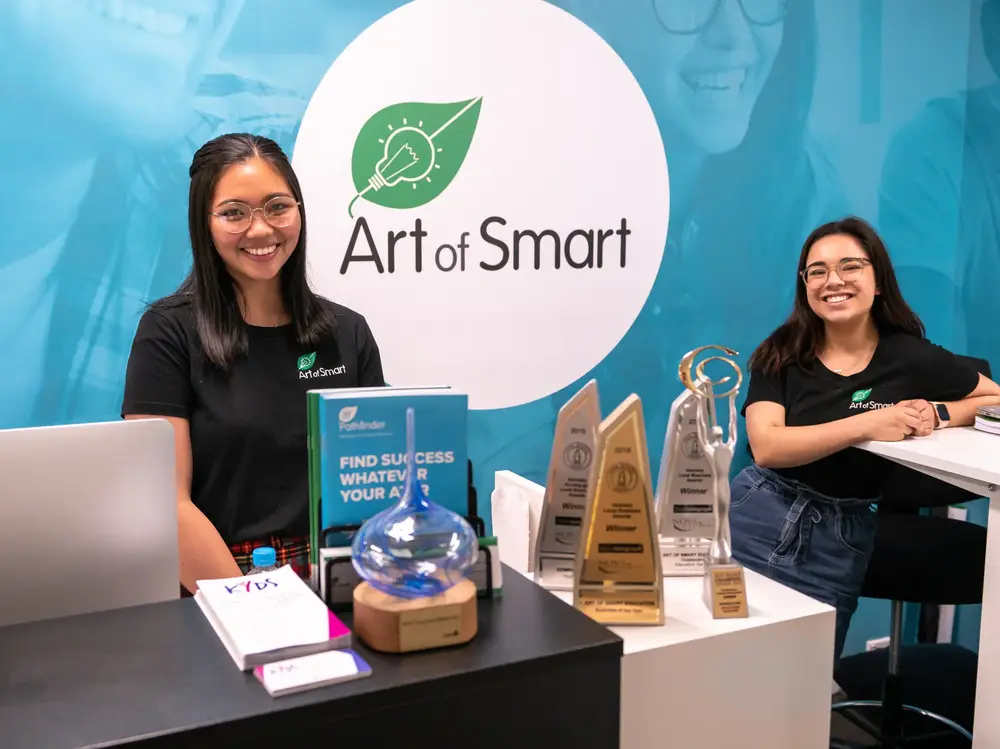 Art of Smart team at reception with industry awards on display